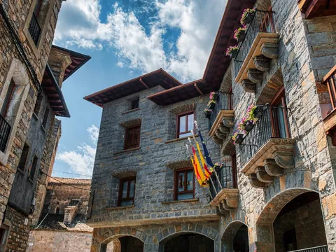 Arquitectura tradicional de piedra con balcones en la plaza de Aínsa, Huesca.