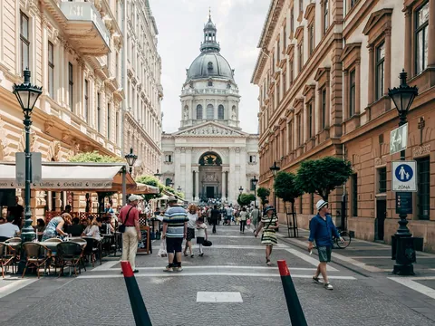 Calle concurrida del centro de Budapest con vista a la Basílica de San Esteban