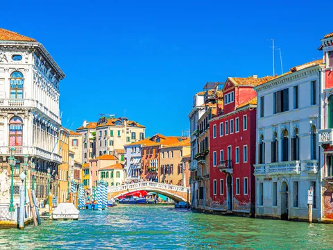 Puente sobre canal rodeado de edificios coloridos en el centro histórico de Venecia