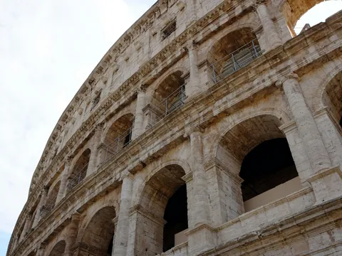 Plano contrapicado de la fachada y arcos del Coliseo Romano en Roma, Italia