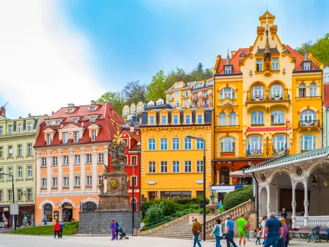 Edificios balnearios de colores vibrantes en la orilla del río de Karlovy Vary.