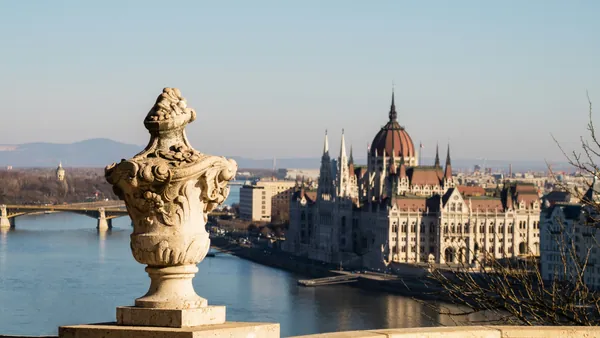 Vista panorámica del Parlamento de Budapest a lo lejos con una urna decorativa.