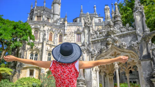 Mujer frente a la fachada de la Quinta da Regaleira en Sintra