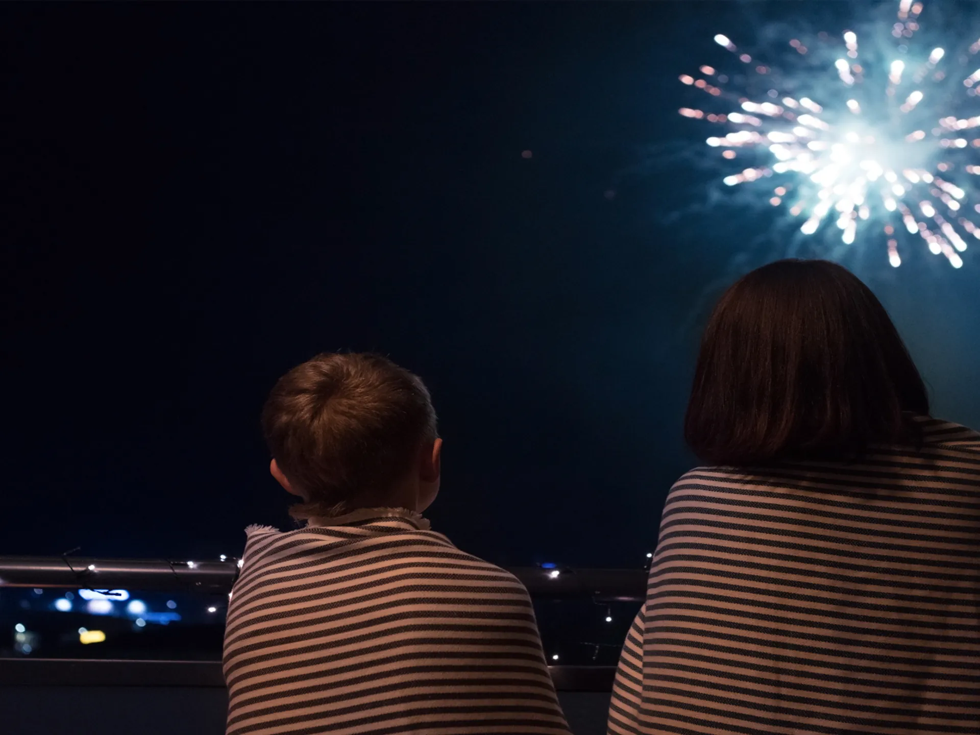 Madre e hijo viendo fuegos artificiales - Cómo se celebra el Año Nuevo en España - Blog - Buendía Tours