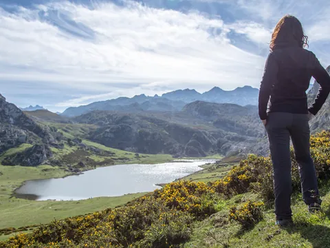 Mujer observando el lago de Covadonga en los Picos de Europa, Asturias