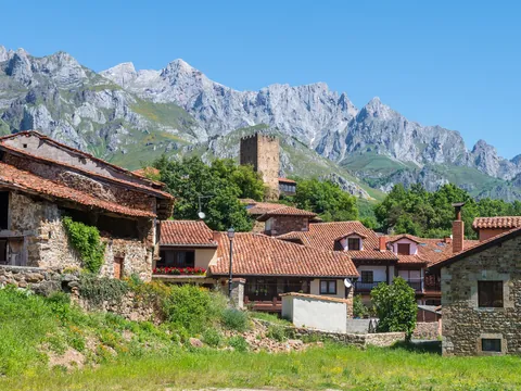 Casas rurales y torre medieval de Mogrovejo ante los Picos de Europa
