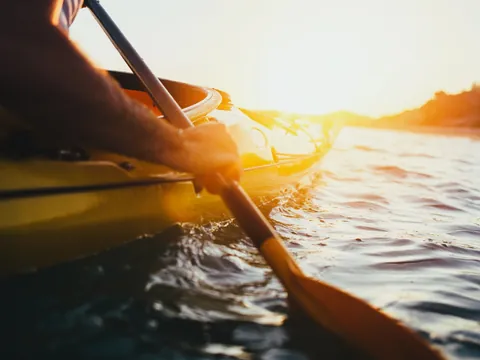 Primer plano de remo y kayak navegando al atardecer en Es Grau, Menorca