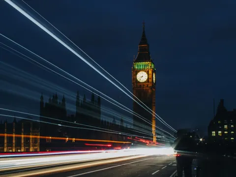 Big Ben iluminado de noche con estelas de luz de vehículos en movimiento