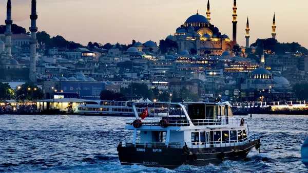 Barco en el Cuerno de Oro con vistas panorámicas de Estambul y Mezquita Azul al atardecer, Turquía