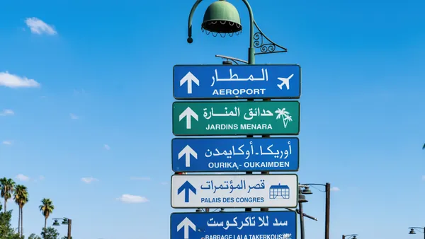 Señales de tráfico hacia el aeropuerto y jardines Menara en Marrakech