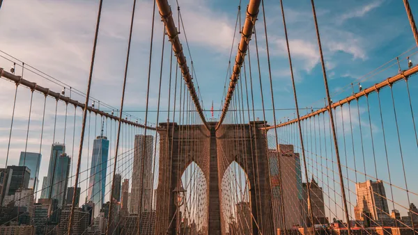 Vista del icónico Puente de Brooklyn y los rascacielos del Lower Manhattan al atardecer, en la ciudad de Nueva York.