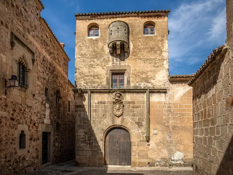 Casa del Sol con su escudo y matacán en Cáceres, España.