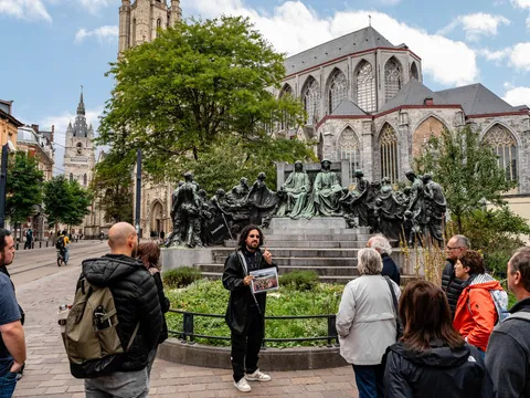 Guía de buendía explicando el monumento a los hermanos Van Eyck, Gante