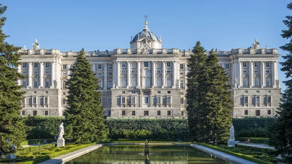Main facade of the Royal Palace of Madrid with the surrounding royal gardens.