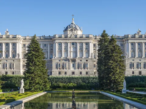Main facade of the Royal Palace of Madrid with the surrounding royal gardens.