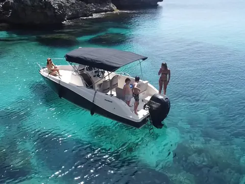 Barco con turistas navegando durante un paseo desde Mahón