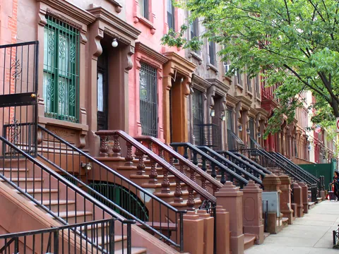 Brownstones tradicionales en una calle residencial de Harlem, Nueva York, Estados Unidos