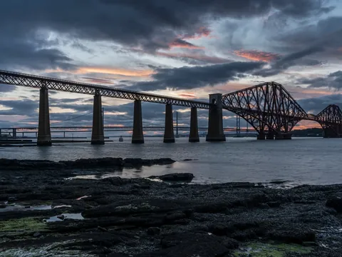 Forth Bridge, puente de hierro icónico en Escocia, al atardecer sobre la Bahía de Forth