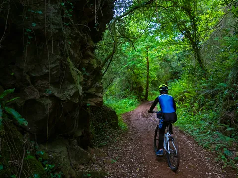 Chico montado en bicicleta por la Vía Verde de la Gándara.